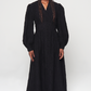 Tznius style V-necked black dress rendered from 70% Viscos and 30% Pes with little velvet flower designs buttons along the front waist panel below the chest and long elegant balloon sleeves with elasticated cuffs full length dress