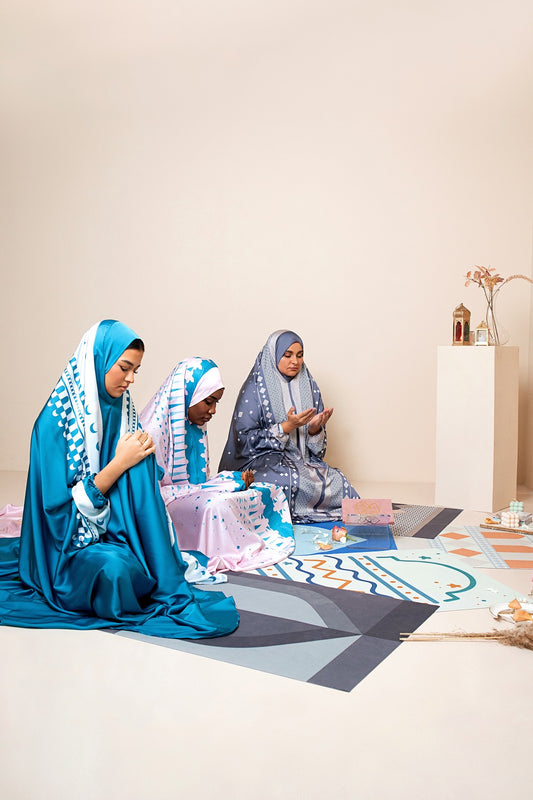 Women offering prayer on Multan compact prayer mat